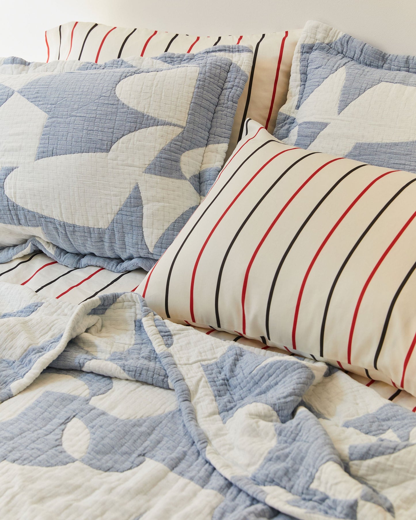 Dusen Dusen Hepta Coverlet Set. Coverlet Set in blue and white Hepta print. Woven matelassé coverlet with inner layer of insulation for a quilted effect. Stone washed, with an extra soft and gauzy hand feel. 100% cotton shell, polyester fill. Machine wash cold and tumble dry low. Made in Portugal.; We know without this Hepta set you’ve wept. We crept in and watched you as you slept. Don’t be bereft, we came prepped. We schlepped to you this coverlet.