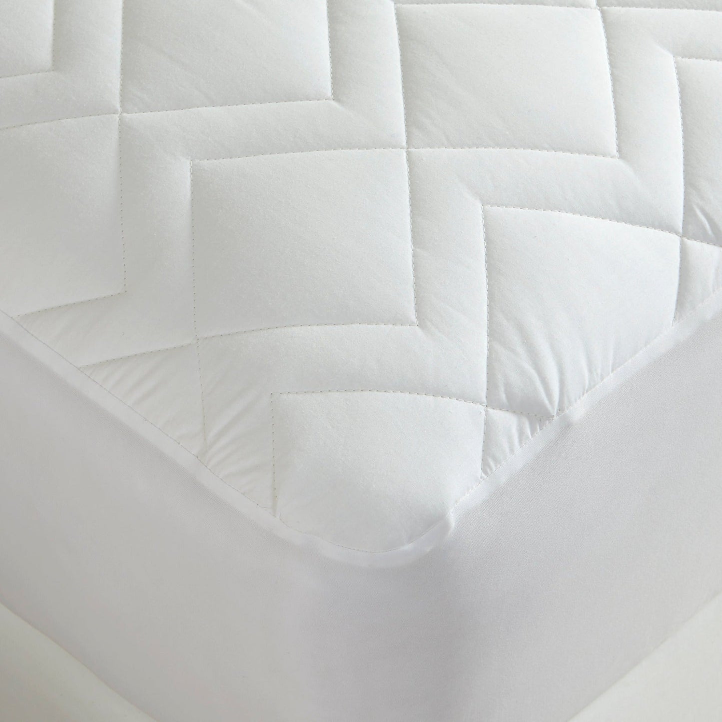 Closeup View of Downtown Company Waterproof Quilted Mattress Pad In Color White