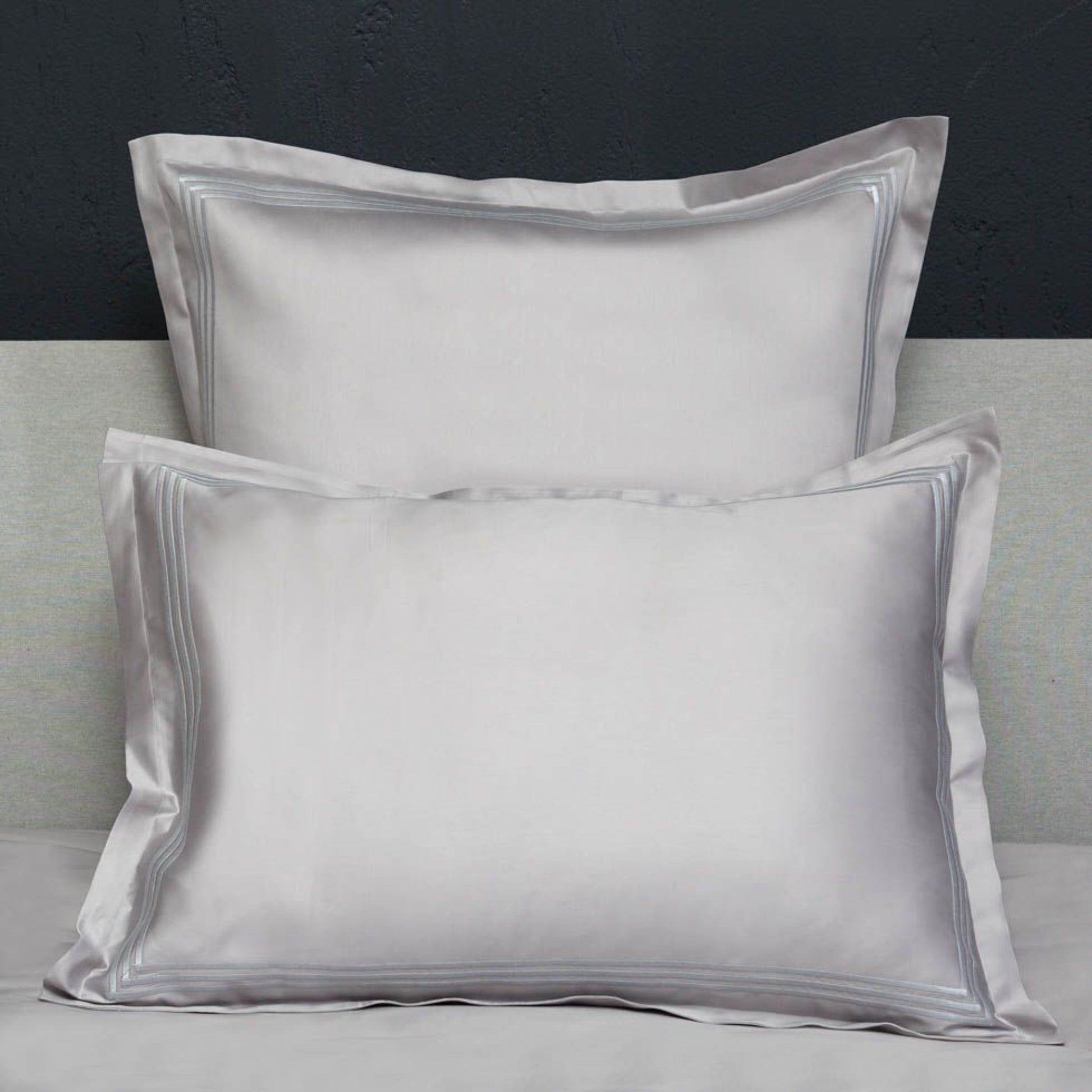 Closeup View of Signoria Platinum Sateen Shams in White/Wilton Blue Color